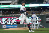 Minnesota Twins' Byron Buxton, left, jogs home to tie the baseball game on a single by Jorge Polanco off Toronto Blue Jays pitcher Steven Matz, center right, in the third inning of a baseball game, Thursday, Sept. 23, 2021, in Minneapolis. (AP Photo/Jim Mone)