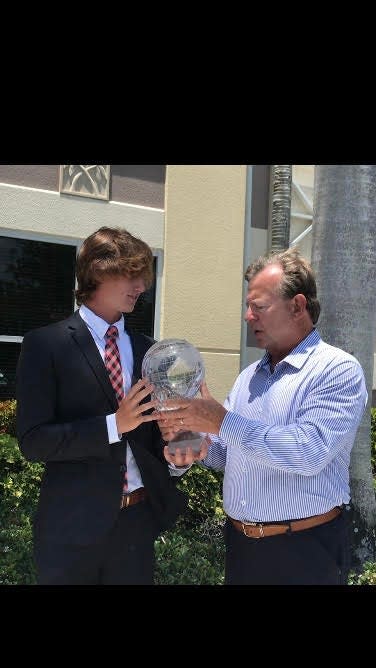 Gulf Coast High School's Trace Davidson, left, is presented the 2021 Winged Foot Scholar-Athlete award by chairman Bud Hornbeck on Thursday, May 27, 2021.