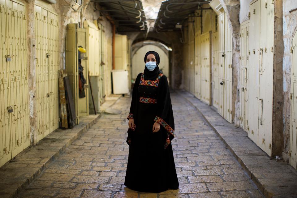 Israeli Arab Rana Hijazi,19, poses for a portrait wearing her protective face mask in the alleys of Jerusalem's old city, Tuesday, July 21, 2020. Hijazi says "she advice all people to wear face masks because it is very important for their health and for the surviving of all humanity" (AP Photo/Oded Balilty)