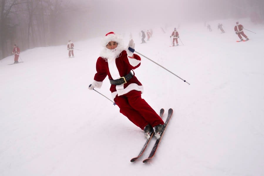 Skiers dressed as Santa Claus hit the slopes, Sunday, Dec. 10, 2023, at the Sunday River ski resort in Newry, Maine. The annual Santa Sunday event raises money for local charities. (AP Photo/Robert F. Bukaty)