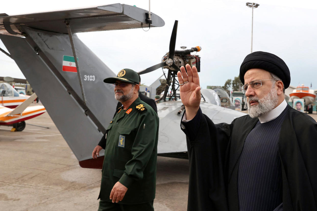 Iranian President Ebrahim Raisi waves as he visits an exhibition. (Iranian Presidency Office / AP)
