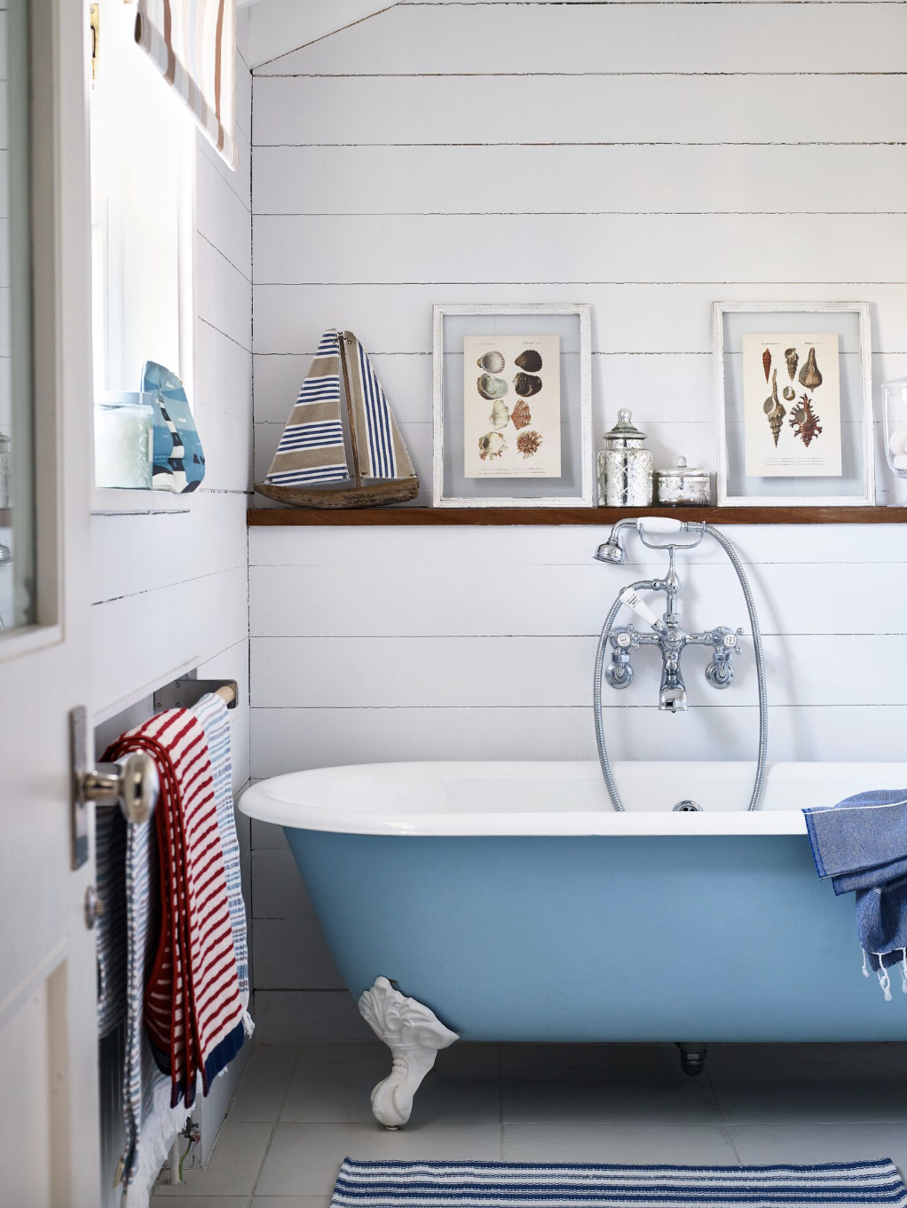 bathroom storage ideas, wooden ledge over the blue tub with a white rim