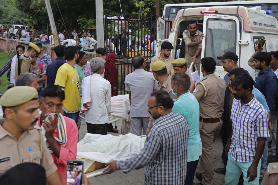 Relatives and volunteers carry the bodies on stretchers at the Sikandrarao hospital in Hathras district about 350 kilometers (217 miles) southwest of Lucknow, India, Tuesday, July 2, 2024. A stampede among thousands of people at a religious gathering in northern India has killed at least 105 and left scores injured, officials said Tuesday, with many women and children among the dead. (AP Photo/Manoj Aligadi)