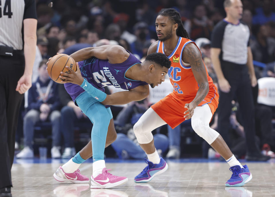 Feb 2, 2024; Oklahoma City, Oklahoma, USA; Charlotte Hornets forward Brandon Miller (24) moves the ball against Oklahoma City Thunder guard <a class="link " href="https://sports.yahoo.com/nba/players/10107/" data-i13n="sec:content-canvas;subsec:anchor_text;elm:context_link" data-ylk="slk:Cason Wallace;sec:content-canvas;subsec:anchor_text;elm:context_link;itc:0">Cason Wallace</a> (22) during the first quarter at Paycom Center. Mandatory Credit: Alonzo Adams-USA TODAY Sports