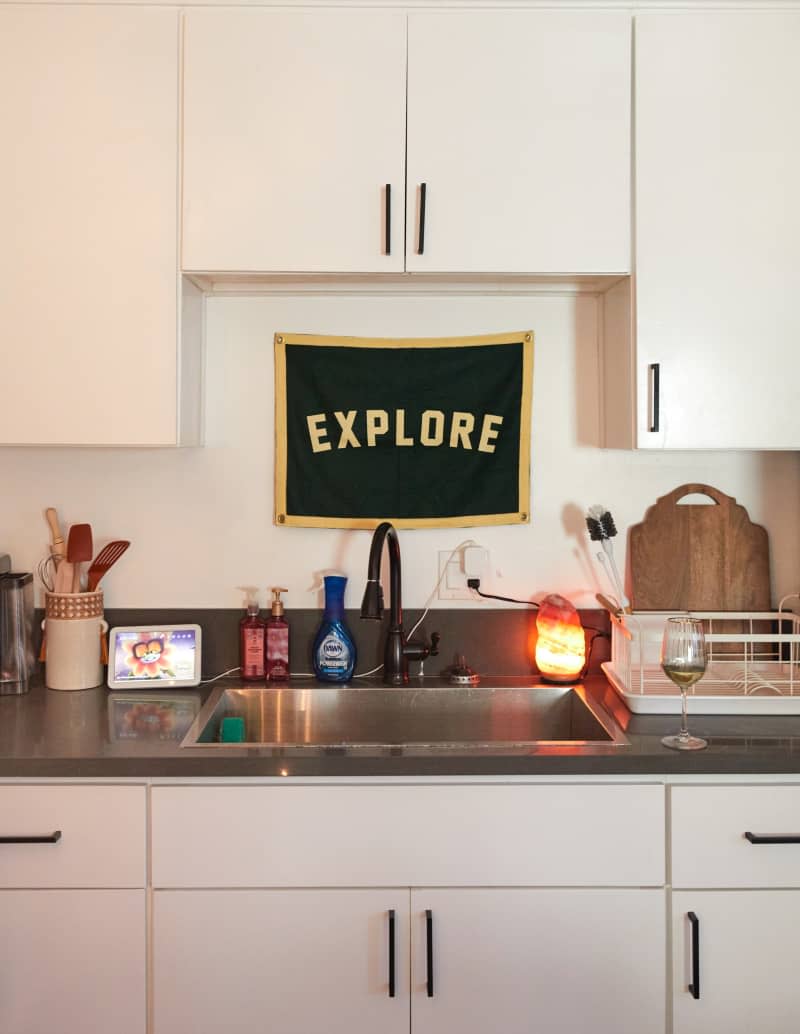 Explore art above the sink of a kitchen.