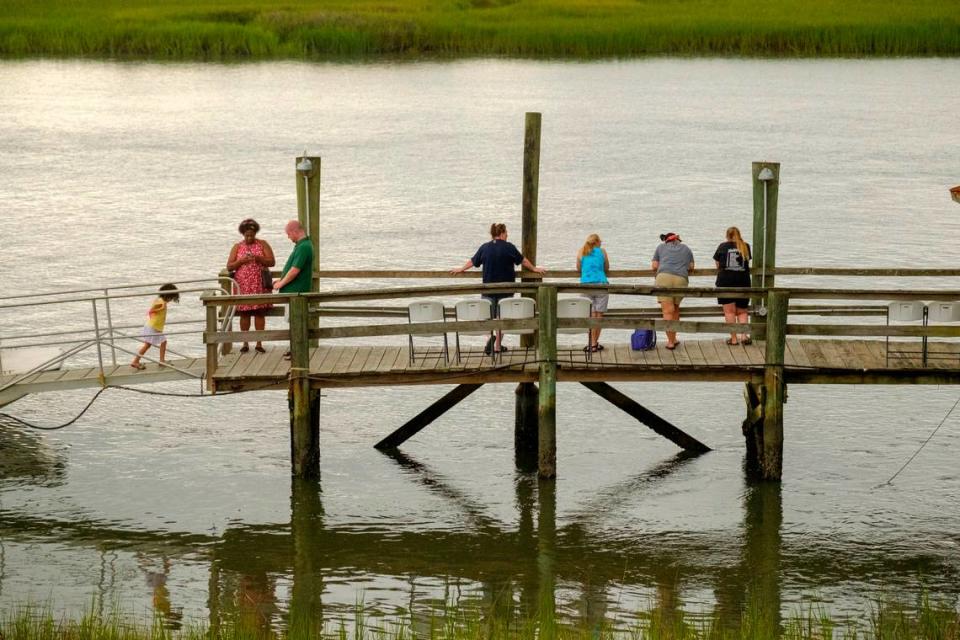 Guests to Bowen’s Island Restaurant look out over the Folly River and surrounding marsh.. Aug. 11, 2021.