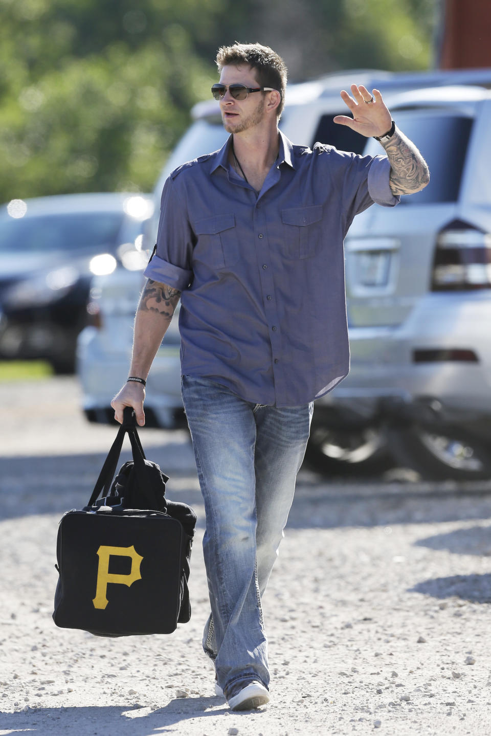 Philadelphia Phillies pitcher A.J. Burnett arrives at Bright House Field before a spring training baseball practice Sunday, Feb. 16, 2014, in Clearwater, Fla. (AP Photo/Charlie Neibergall)