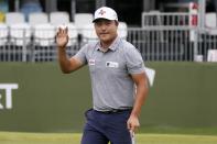 Kyoung-Hoon Lee, of South Korea, acknowledges applause from the gallery after his putt on the 17th green during the final round of the AT&T Byron Nelson golf tournament in McKinney, Texas, Sunday, May 16, 2021. (AP Photo/Ray Carlin)
