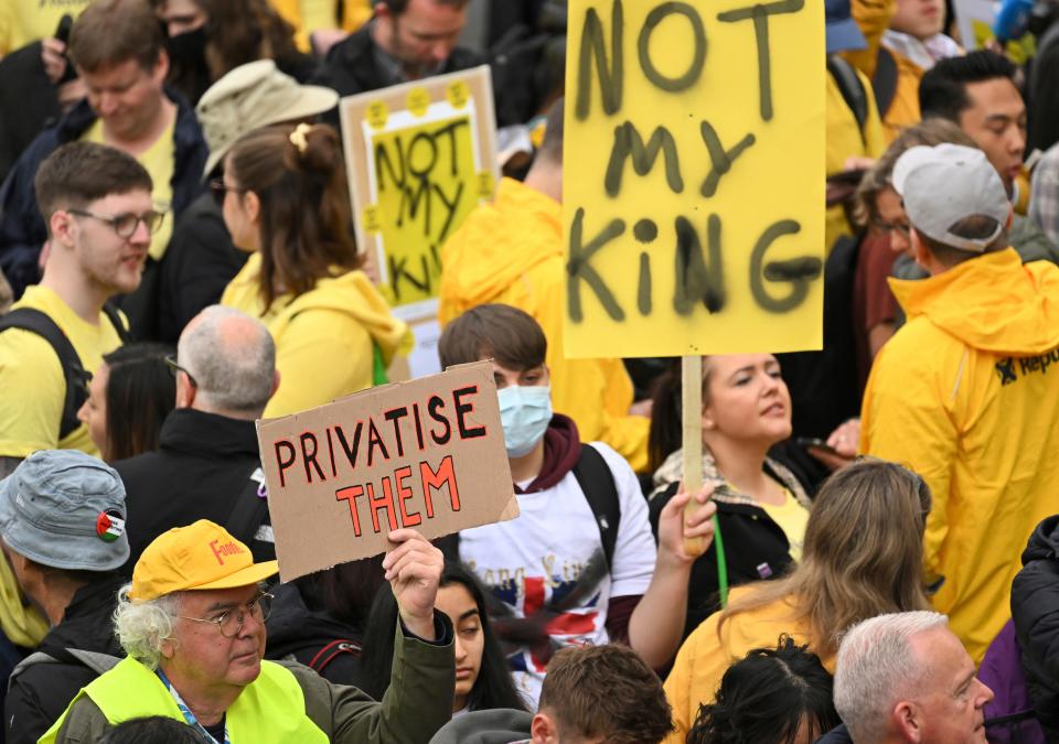Protesters hold up placards reading 'Not My King' in Trafalgar Square, ahead of the coronation of King Charles III and Camilla, the Queen Consort, in London, Saturday, May 6, 2023.