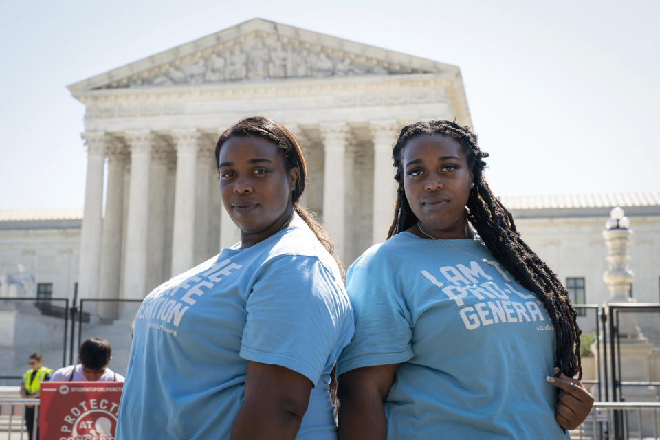 K'Vone Cropp, 26, left, and her twin sister Kayla Cropp, 26, of Richmond, Va., pose for a portrait while protesting with the group Students For Life, outside the Supreme Court about abortion, Wednesday, June 15, 2022, in Washington. "We aren't big talkers," said Kayla. "We are just here supporting the cause and abolishing abortion." (AP Photo/Jacquelyn Martin)