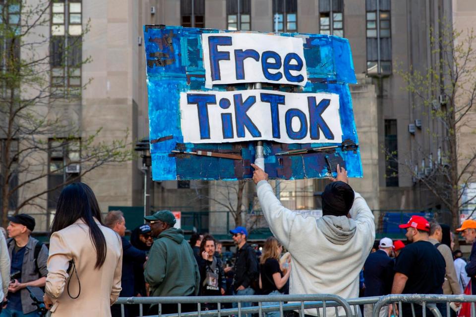 PHOTO: A man carries a Free TikTok sign in front of the courthouse where the hush-money trial of Donald Trump got underway April 15, 2024, in New York.  (Ted Shaffrey/AP)