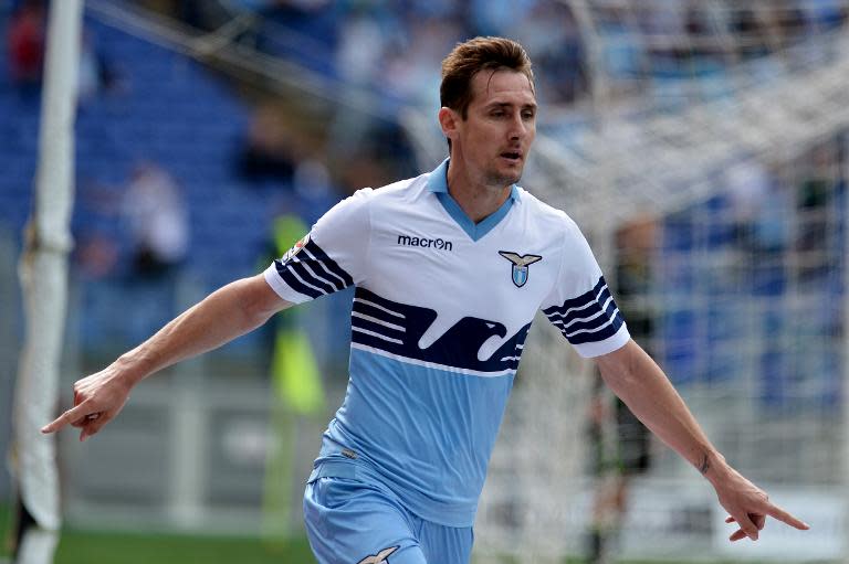 Lazio's Miroslav Klose celebrates after scoring during the Serie A match against Chievo on April 26, 2015 in Rome