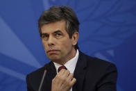 Brazil's new Health Minister Nelson Teich listens to a question during his first press conference amid the new coronavirus pandemic, at the Planalto Presidential Palace, in Brasilia, Brazil, Wednesday, April 22, 2020. Teich, an oncologist, was sworn in as health minister last week after his predecessor was fired by President Jair Bolsonaro, who has downplayed the threat of COVID-19. (AP Photo/Eraldo Peres)