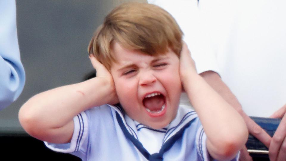 Prince Louis covers his ears as mum Princess Kate laughs as they watch the RAF flypast at Trooping the Colour in 2022