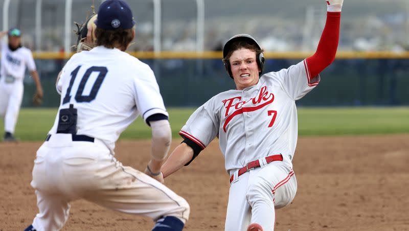 American Fork’s Ryder Robinson (7) steals third base before getting tagged by Westlake’s Mason Hartle (10) at Westlake High in Saratoga Springs on Thursday, April 27, 2023.