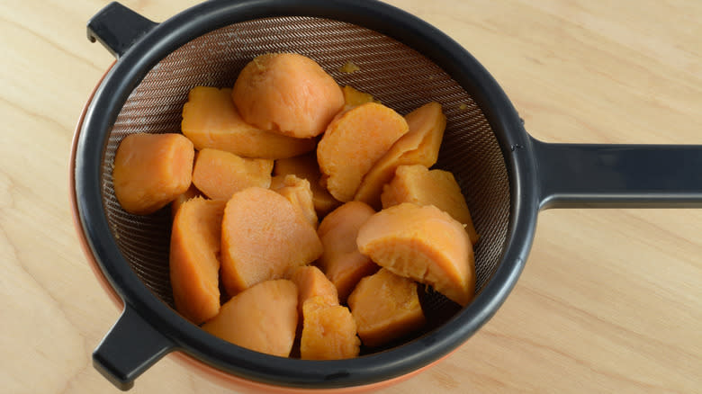 Canned sweet potatoes in strainer