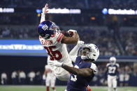 New York Giants wide receiver Darius Slayton (86) catches a pass for a first down as Dallas Cowboys cornerback Anthony Brown (3) defends during the first half of an NFL football game Thursday, Nov. 24, 2022, in Arlington, Texas. (AP Photo/Michael Ainsworth)