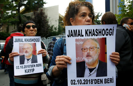 Human rights activists hold pictures of Saudi journalist Jamal Khashoggi during a protest outside the Saudi Consulate in Istanbul, Turkey October 9, 2018. REUTERS/Osman Orsal/Files