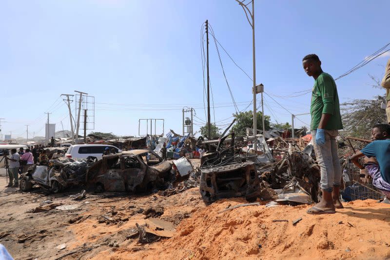 A Somali man stands at the scene of a car bomb explosion at a checkpoint in Mogadishu