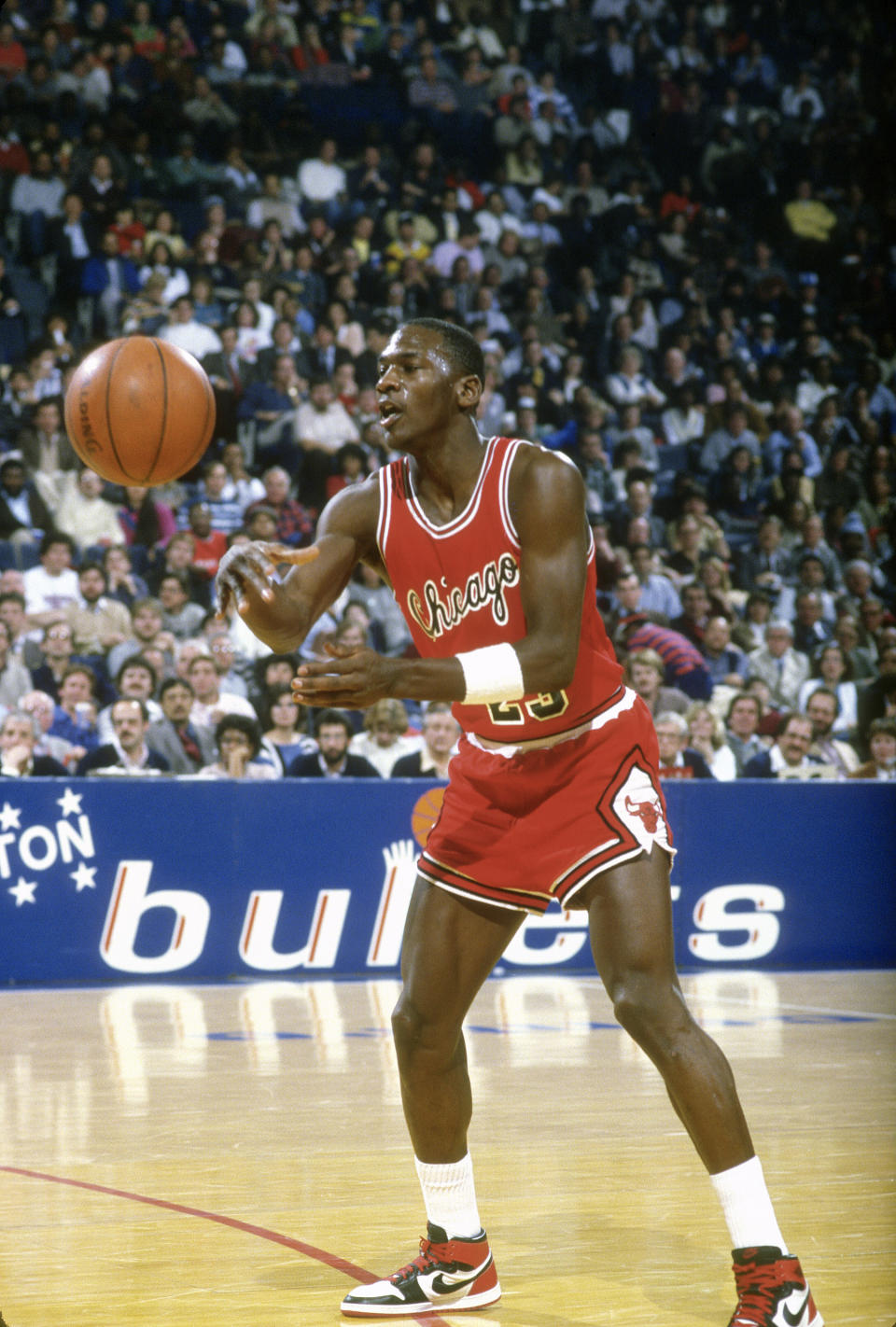 air jordan 1 history, LANDOVER, MD - CIRCA 1985: Michael Jordan #23 of the Chicago Bulls passes the ball against the Washington Bullets during an NBA basketball game circa 1985 at the Capital Centre in Landover, Maryland. Jordan played for the Bulls from 1984-93 and 1995 - 98. (Photo by Focus on Sport/Getty Images) *** Local Caption *** Michael Jordan