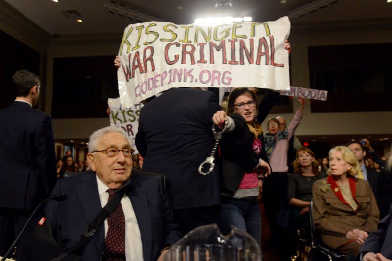 Code Pink activists protest as former Secretary of State Henry Kissinger arrives to testify before the Senate Armed Services Committee hearing on global challenges and U.S. national security strategy in Washington in 2015. File Photo by Molly Riley/UPI