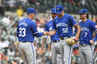 Kansas City Royals manager Matt Quatraro, left, takes the ball away from starting pitcher Michael Wacha (52) after Wacha gave up a home run to Detroit Tigers' Jake Rogers in the sixth inning of a baseball game, Sunday, April 28, 2024, in Detroit. (AP Photo/Jose Juarez)