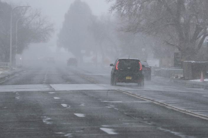 A flurry of snow lowers driver visibility in Las Cruces on Sunday, Feb. 14, 2021.