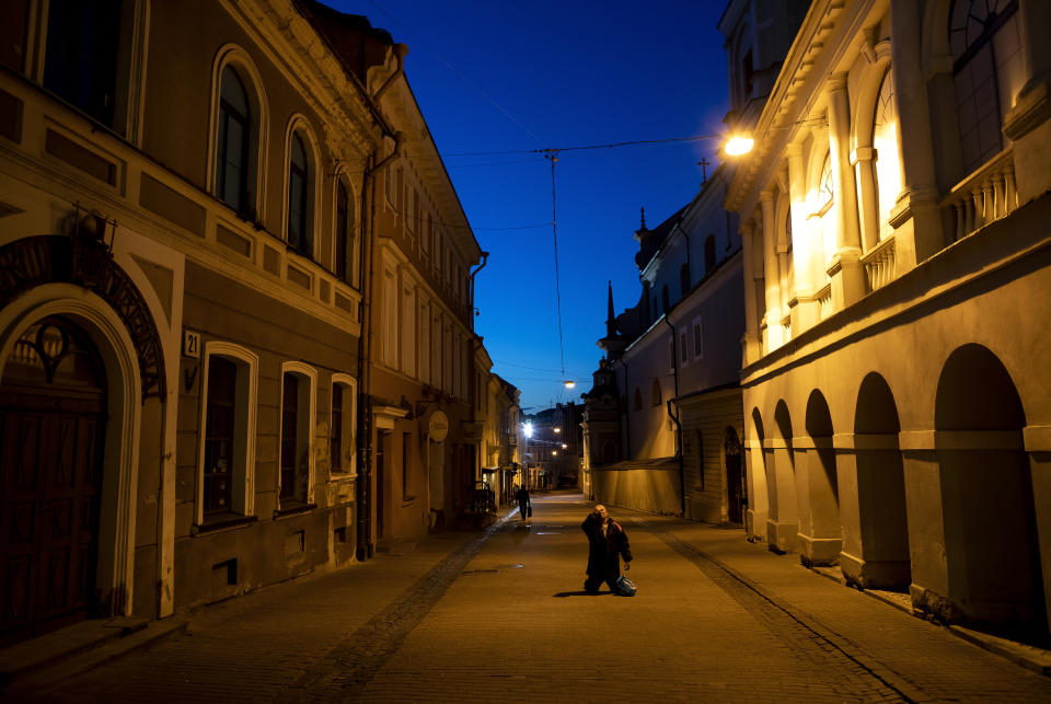 A worshipper prays during the celebrations marking Easter, at the chapel of Our Lady of the Gate of Dawn, in Vilnius, Lithuania, Saturday, April 11, 2020. The church cancelled all worship services but some people came to the chapel to celebrate Easter nearby. The new coronavirus causes mild or moderate symptoms for most people, but for some, especially older adults and people with existing health problems, it can cause more severe illness or death. (AP Photo/Mindaugas Kulbis)