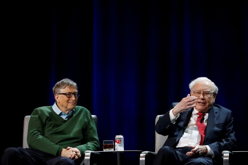 FILE PHOTO: Warren Buffett, chairman and CEO of Berkshire Hathaway, speaks while Bill Gates looks on at Columbia University in New York