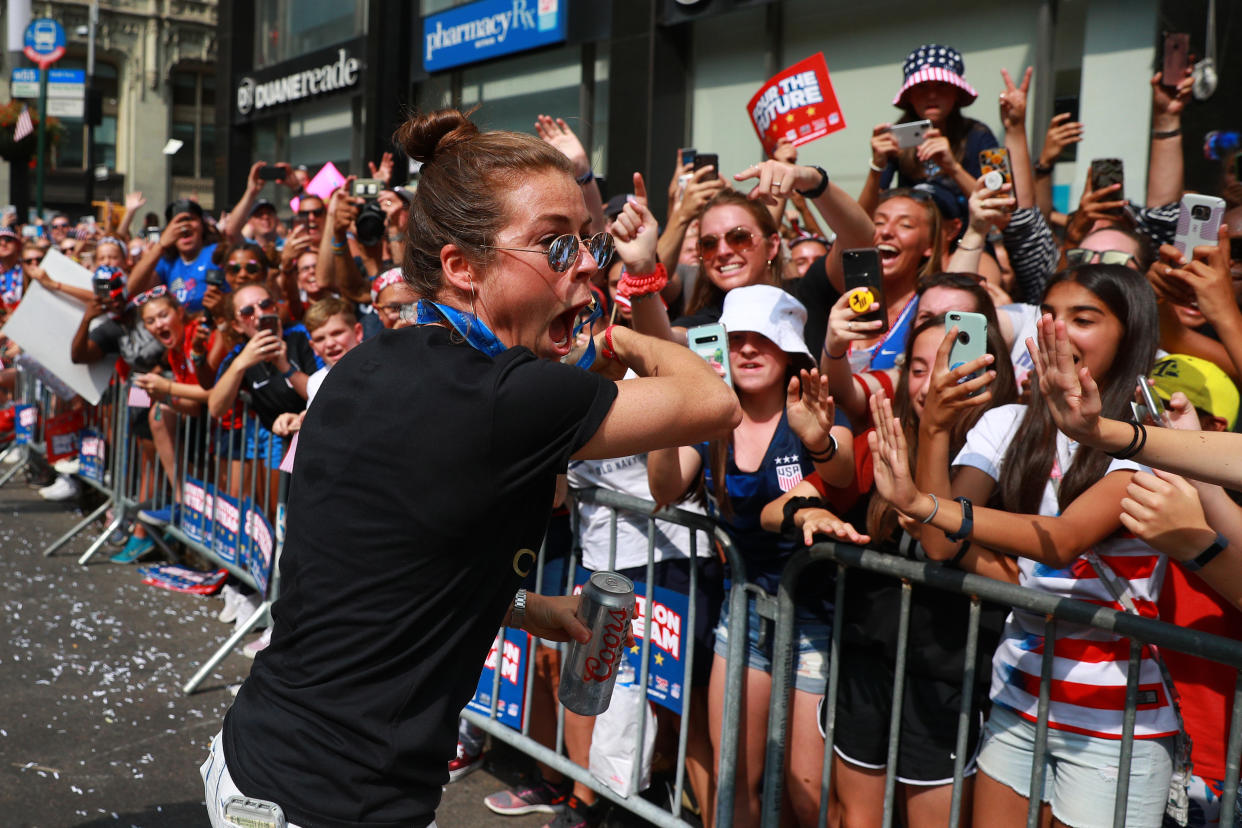 Kelley O'Hara of the U.S. women's soccer team celebrates with fans during a parade along the Canyon of Heroes, July 10, 2019, in New York. (Photo: Gordon Donovan/Yahoo News)