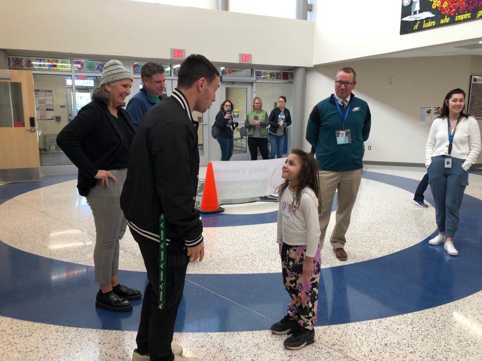 Eagles wide receiver Britain Covey speaks in Spanish with a Neidig Elementary School student during his visit to the school Wednesday.