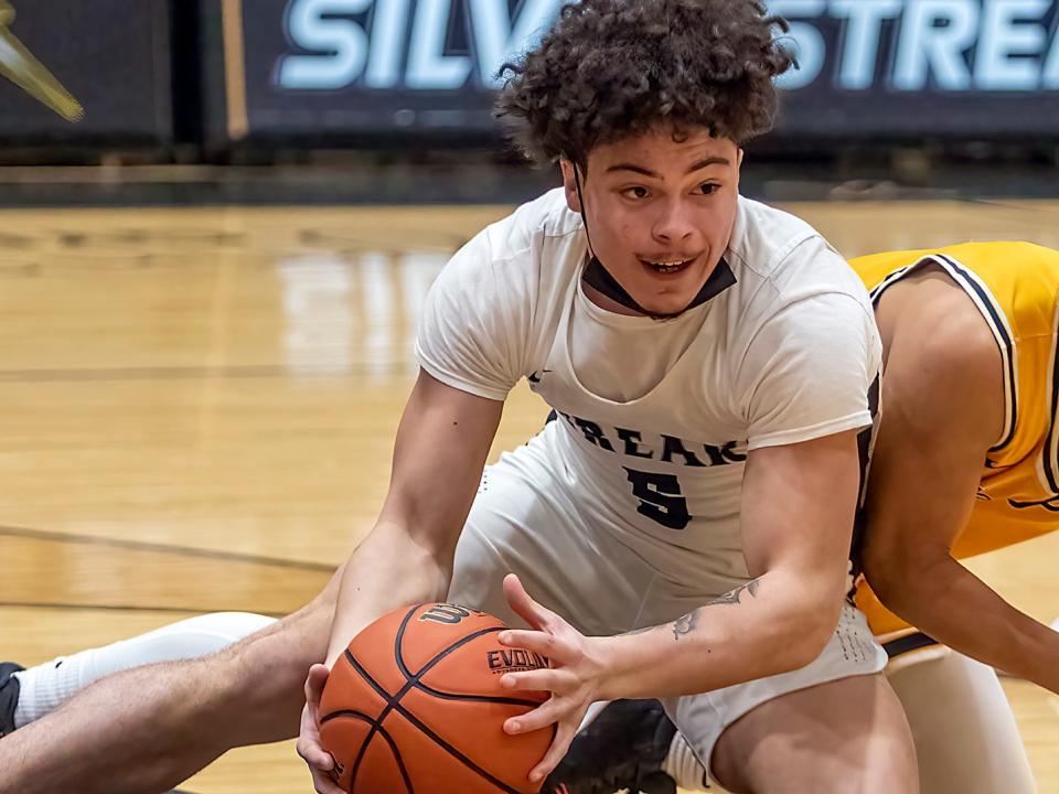 Galesburg High School senior Dre Egipciaco looks for an open teammate after scrambling for a loose ball during the Silver Streaks' 73-48 WB6 Conference win over Sterling on Tuesday, Jan. 25, 2022 at John Thiel Gymnasium.