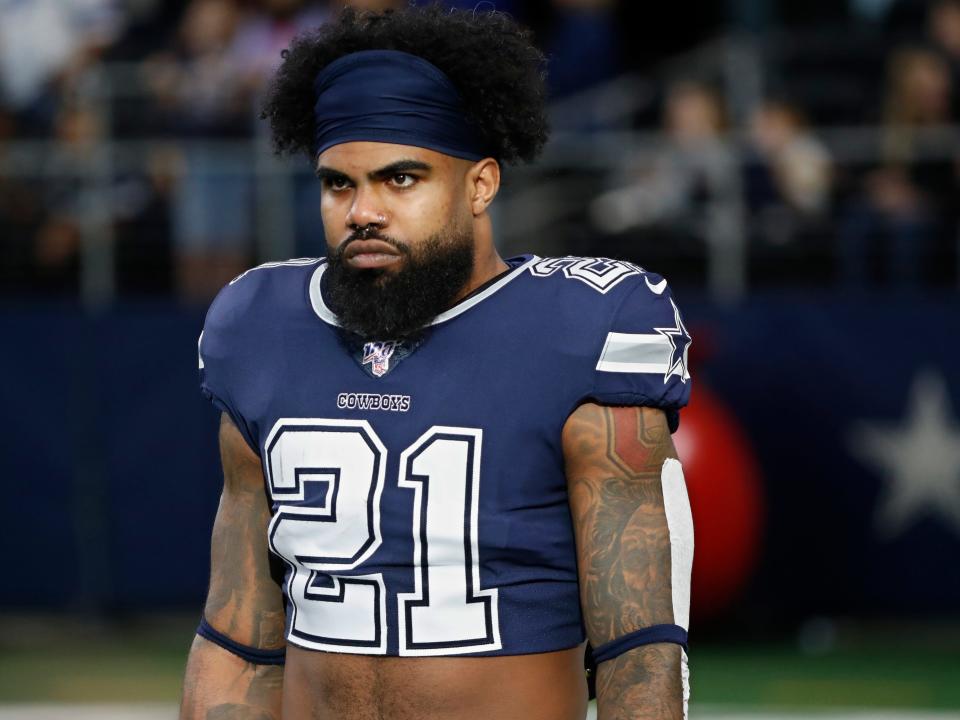 FILE - In this Dec. 15, 2019, file photo, Dallas Cowboys running back Ezekiel Elliott (21) warms up before an NFL football game against the Los Angeles Rams in Arlington, Texas. Ezekiel Elliott tested positive for the coronavirus, according to his agent. Rocky Arceneaux told the NFL Network on Monday, June 15, 2020, that Elliott was feeling OK and recovering.(AP Photo/Roger Steinman, FIle)