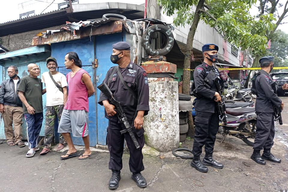 Police officers stand guard near a police station where an explosion went off in Bandung, West Java, Indonesia, Wednesday, Dec. 7, 2022. An unidentified attacker blew himself up outside a police station in Indonesia’s main island of Java on Wednesday in a latest of suicide attacks in the world’s most populous Muslim nation, police said. (AP Photo/Ahmad Fauzan)