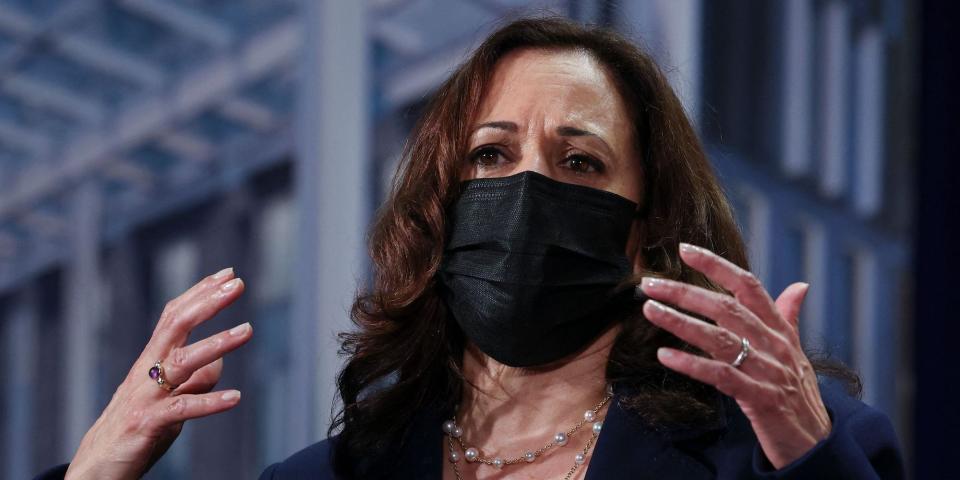 Kamala Harris speaking and gesturing during a trip to Vietnam.