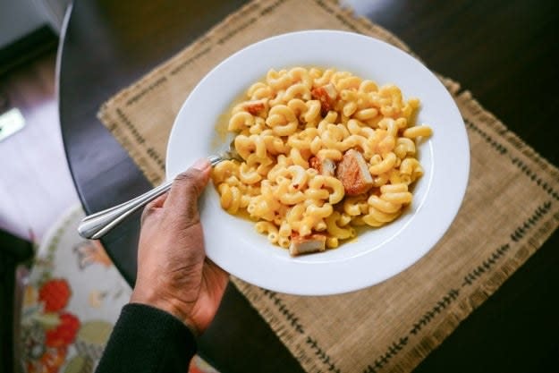 carrying a bowl of mac and cheese