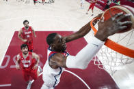 United States' Bam Adebayo dunks the ball ahead of Iran's Behnam Yakhchalidehkordi (88) during a men's basketball preliminary round game at the 2020 Summer Olympics, Wednesday, July 28, 2021, in Saitama, Japan. (Charlie Neibergall/Pool Photo via AP)