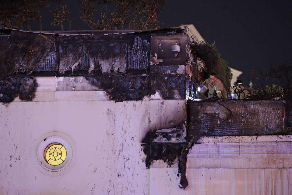 Firefighters inspect fire damage at the Bellagio hotel and casino along the Las Vegas Strip, Thursday, April 13, 2017, in Las Vegas. (AP Photo/John Locher)