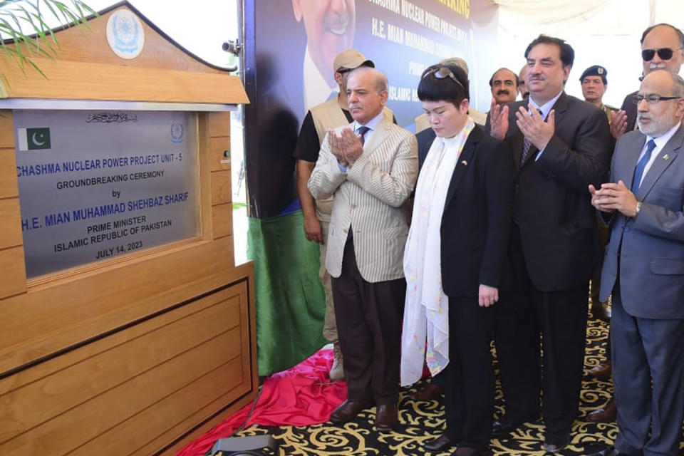 In this photo released by Press Information Department, Pakistan's Prime Minister Shehbaz Sharif, center, and other officials pray during the groundbreaking ceremony of 5th Unit of Chashma Nuclear Power Plant (Chashma-5) in Chashma, Mianwali, Pakistan, Friday, July 14, 2023. Sharif launched the construction of a 1,200-megawatt Chinese-designed nuclear energy project, which will be built at a cost of $3.5 billion as part of the government efforts to generate more clean energy in the Islamic nation. (Press Information Department via AP)