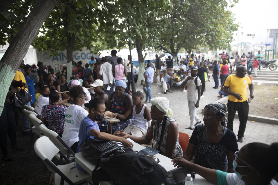 FILE - Residents who were displaced from their homes due to clashes between armed gangs in La Plaine, are examined at a mobile medical clinic in the Tabare neighborhood of Port-au-Prince, Haiti, May 13, 2022. Close to 60% of Haiti’s capital is dominated by gangs whose violence and sexual attacks have caused thousands to flee their homes, the U.N. humanitarian chief in the Caribbean nation said Thursday, Dec. 8, 2022. (AP Photo/Odelyn Joseph)