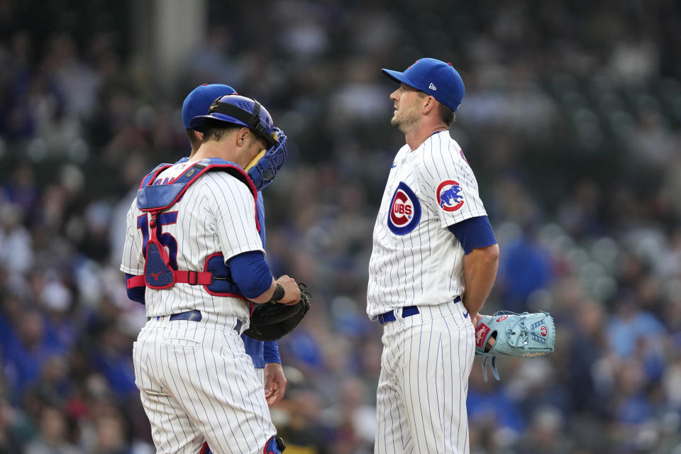 Chicago Cubs starting pitcher Drew Smyly, right, listens to pitching coach Tommy Hottovy and catcher Yan Gomes during the third inning of the team's baseball game against the Pittsburgh Pirates on Wednesday, June 14, 2023, in Chicago. (AP Photo/Charles Rex Arbogast)