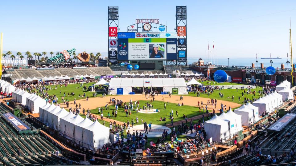 Nov 2, 2019 San Francisco / CA / USA - Panoramic view of Oracle Park during the Bay Area Science Festival event; People visiting the business representative booths set up on the field.