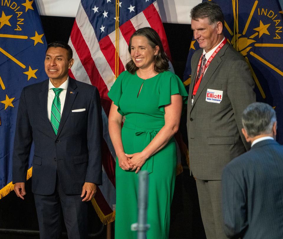 From left, Diego Morales, Tera Klutz, and Daniel Elliott smile for photos after winning the day’s voting, state GOP Convention, Indiana Farmer’s Coliseum, Indianapolis, Saturday, June 18, 2022. 