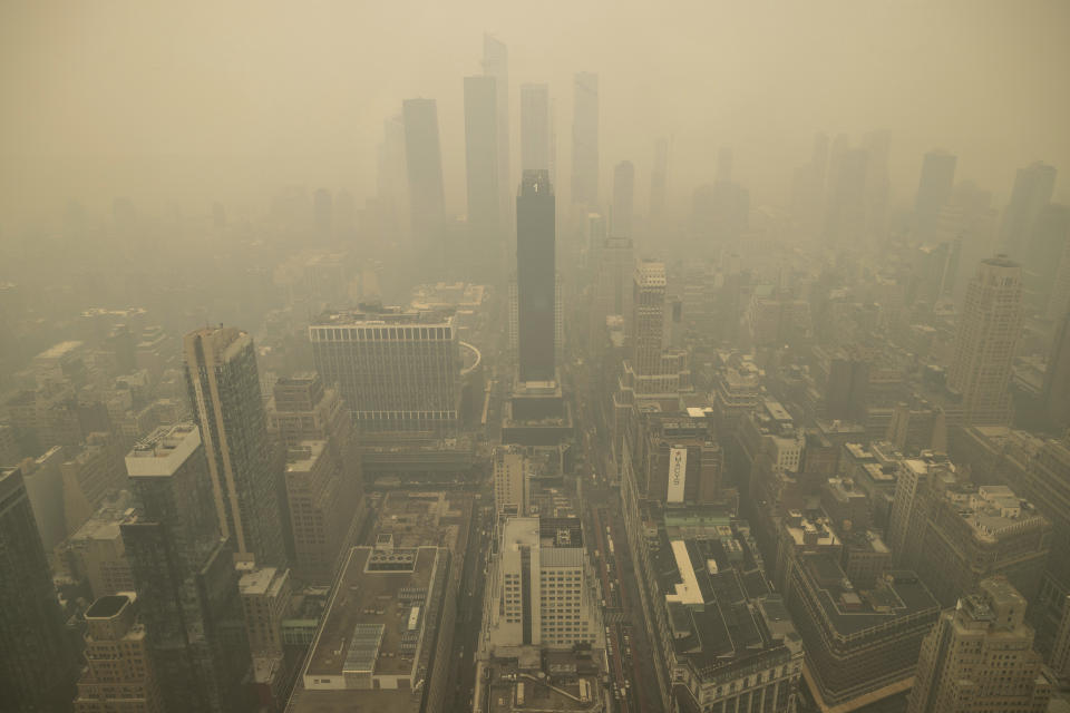 An aerial view shows New York City in a haze-filled sky from the Empire State Building observatory, Wednesday, June. 7, 2023, in New York. Smoke from Canadian wildfires poured into the U.S. East Coast and Midwest on Wednesday, covering cities of both nations in an unhealthy haze, holding up flights at major airports and prompting people to fish out pandemic-era face masks. (AP Photo/Yuki Iwamura)