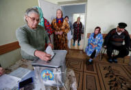 A local resident casts her ballot into a portable ballot box at a hospital during a presidential election in the village of Kozhushna, outside Chisinau, Moldova, October 30, 2016. REUTERS/Gleb Garanich