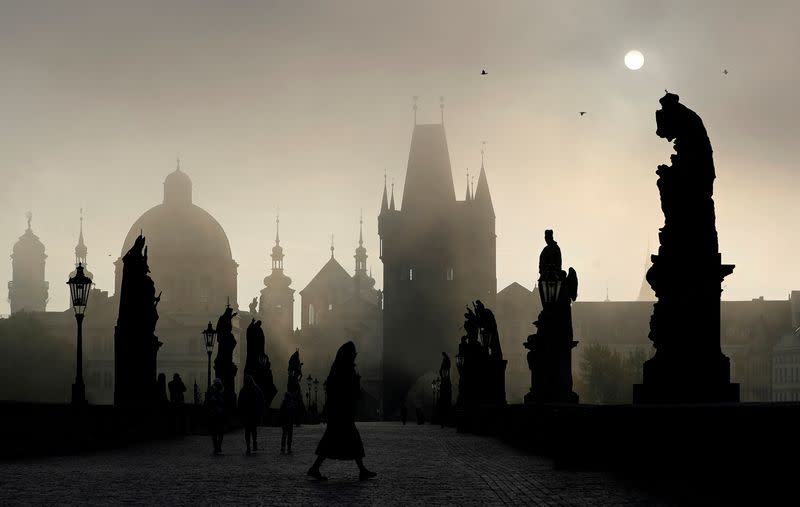 Sun rises over the medieval Charles Bridge in Prague