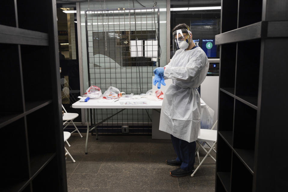 A medical worker works at COVID-19 testing site in Times Square subway station on Thursday, Dec. 30, 2021, in New York. Thanks to the highly contagious omicron variant that was first identified as a variant of concern last month, new COVID-19 cases in the U.S. have soared to their highest levels on record. (AP Photo/Yuki Iwamura)