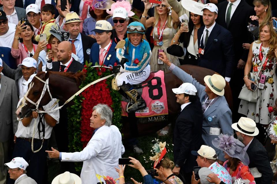 Javier Castellano pitches ones from the garland to the crowd in the Winner’s Circle following his victory aboard Mage in the 147th running of The Kentucky Derby, Saturday, May 6, 2023 in Louisville, Ky.