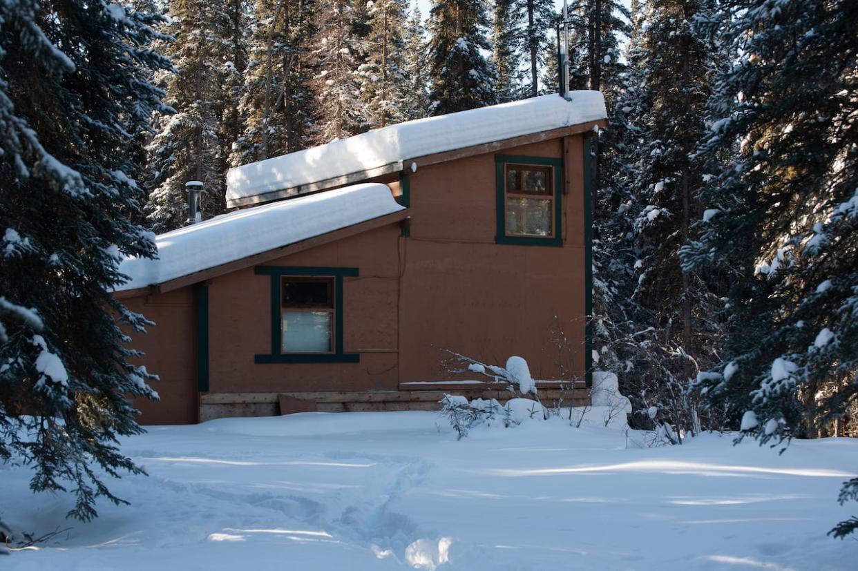 A 2-storey cabin built on a placer claim near Little Atlin Lake, seen last year. The Yukon government has ordered the claim holder to dismantle it. (Julien Gignac/CBC  - image credit)