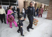 File-This Jan. 15, 2011, file photo shows Harwinder Dhaliwal walking behind daughter Japdeep Dhaliwal, 4, and husband Deputy Sandeep Dhaliwal after the Basic Peace Officer Course Class BRI-2010 Graduation Ceremony, in Houston. Dhaliwal, described as “a trailblazer” because he was the first Sikh deputy of the Harris County Sheriff's Office when he joined the force 10 years ago, was shot and killed while making a traffic stop Friday, Sept. 27, 2019, near Houston. (Mayra Beltran/Houston Chronicle via AP, File)